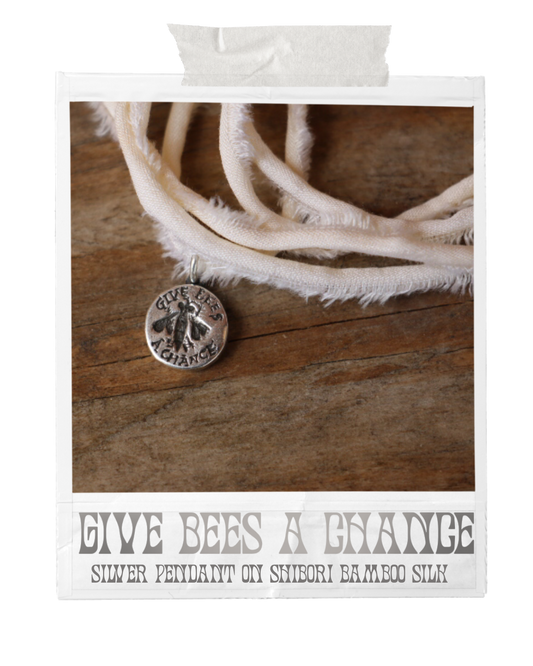 handmade sterling silver bee pendant on a bamboo silk ribbon
